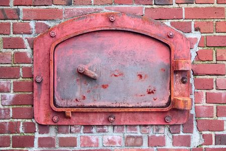 The old red door of the brick incinerator, from the turn of the 20th century.の写真素材