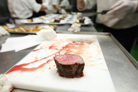 Chef in hotel or restaurant kitchen cooking for dinnerの写真素材