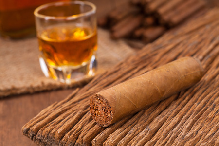 cigars and whisky on old wooden tableの写真素材