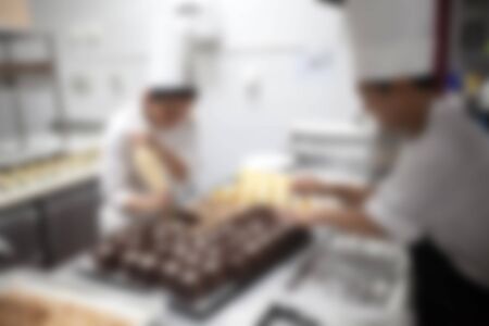 Blurry of Chef in hotel or restaurant kitchen cooking for partyの写真素材