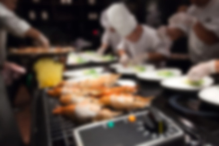 Blurry of Chef in hotel or restaurant kitchen cooking for party