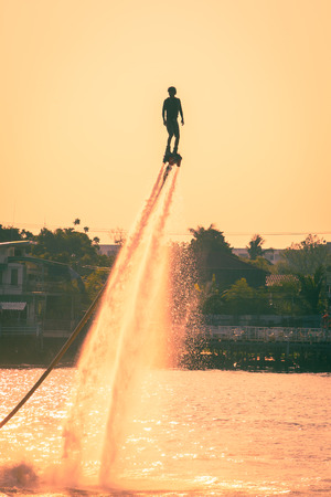 NONTHABURI, THAILAND - February 27 2015:  Silhouette and vintage color styl  of showing flyboard on Chaophya river during Chinese new year celebrations on February 27, 2015 Nonthaburi, Thailand.のeditorial素材