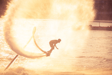 Silhouette and vintage color styl showing flyboard on Chaophya riverのeditorial素材