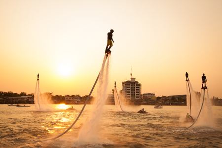 NONTHABURI, THAILAND - March 1, 2015:  Silhouette and vintage color styl  of showing flyboard on Chaophya river during Chinese new year celebrations on March 1, 2015 Nonthaburi, Thailand.のeditorial素材