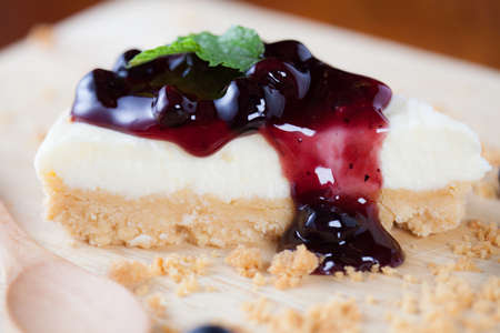 Close up blueberry cake on wooden plate on wood table.の写真素材