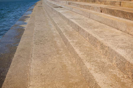 Abstract concrete stairs to building background. Cement dirty grunge staircase with seaside.の写真素材