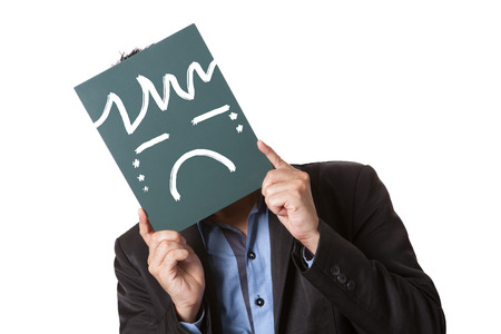 Businessman holding green blackboard isolated on white background with drawing sad emoticon on blackboard.の写真素材