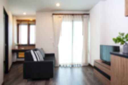 blurry background of corner living room in condominium on high floor.