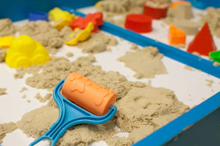 Plastic Mold toys with sand on sandbox. Background blurry.の写真素材