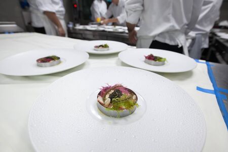 Chef cooking food with Caviar and shrimp for dinner party in the restaurant kitchen.