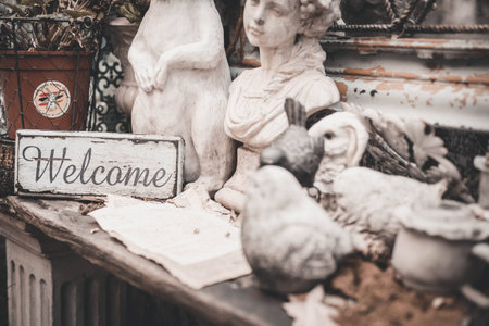 Vintage welcome signboard with animal and human statue.の写真素材