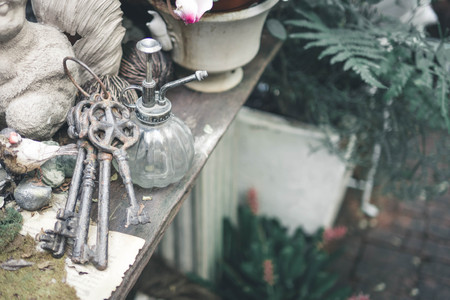 Vintage keys and vase in garden.の写真素材