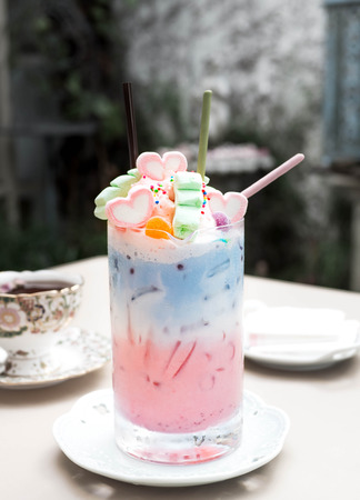 Pastel milk (drink.beverage) topping with marshmallow and pocky in long glass.の写真素材
