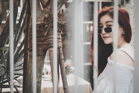 Smilling women in the garden vintage style.fashion,holiday and lifestyle.の写真素材