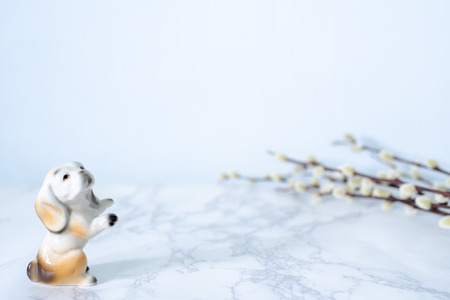 Ceramic dog and cotton flower on marble table for background.の写真素材