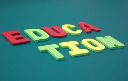 Education words on blackboard and colorful wood lettersの写真素材