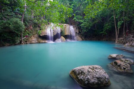 Large blue lake and flowing water at Erawan Waterfall - Thailandの写真素材