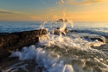 Stones and waves during sunrise in Songkha, Thailandの写真素材