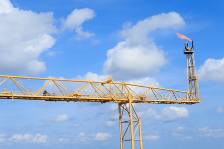 Hot flare boom and fire on offshore production platformの写真素材