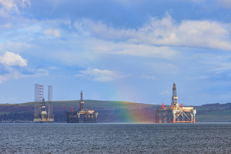 Semi Submersible Oil Rig with rainbow after Raining at Cromarty Firth in Invergordon, Scotlandの写真素材