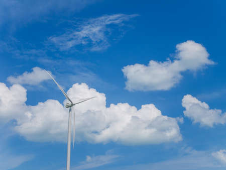 Wind turbine with blue sky and white clouds backgroundの写真素材