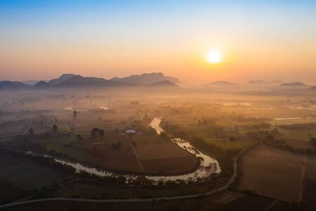 Aerial view from a drone of misty morning over the river in Kanchanaburi, Thailand