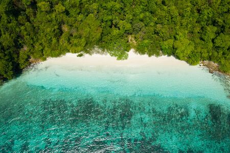 Aerial view from a drone of beautiful Nyaung Oo Phee island on sunny day in Myanmar