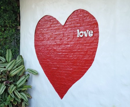 Love text and red heart in wall の写真素材