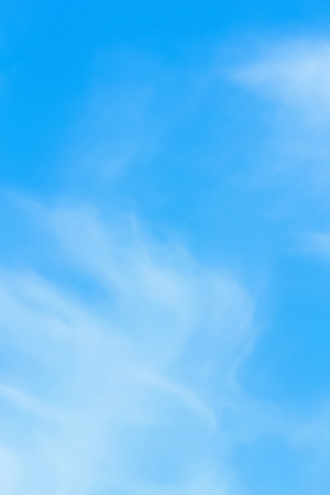 clear blue sky with plain white cloud with space for textの写真素材