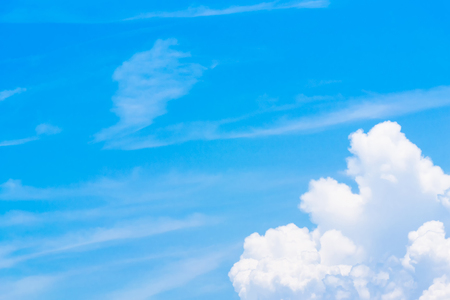 Blue sky background with tiny clouds. White fluffy clouds in the blue skyの写真素材