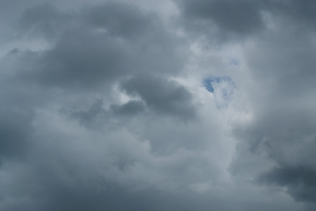 Before the rain fell, the clouds gathered together in the darkness of the sky.