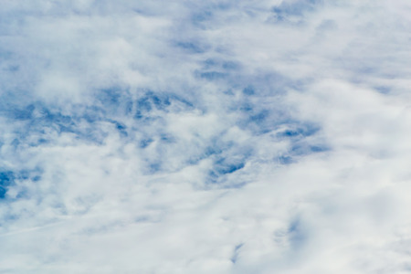 The blue backdrop has some clouds.