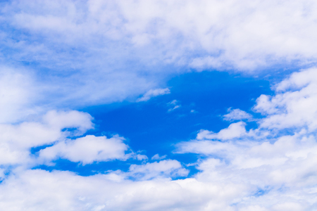 clear blue sky with plain white cloud with space for text.の写真素材