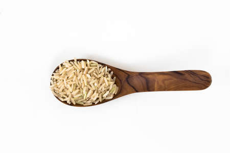 Rice on wooden spoon wiht white backgroundの写真素材