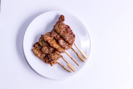 Thai style grilled pork on white backgroundの写真素材