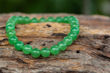 The Aventurine Stone Bracelet on the stump woodの写真素材