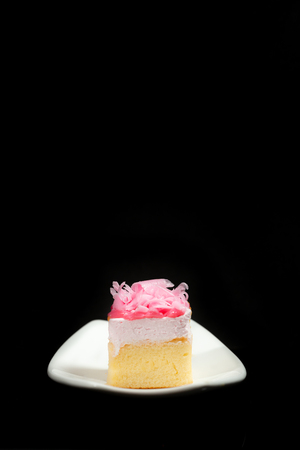 Sweet Cake on white dish on black backgroundの写真素材