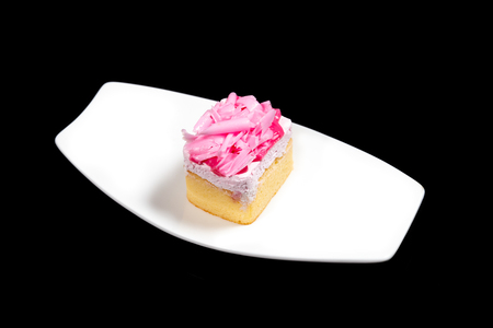Sweet Cake on white dish on black backgroundの写真素材