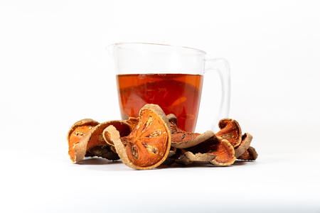 Slices of dried bael fruit on white backgroundの写真素材