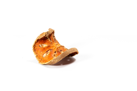 Slices of dried bael fruit on white backgroundの写真素材