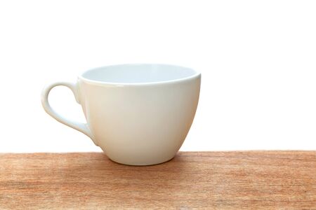 Cup of coffee on a wooden table over white background.の写真素材