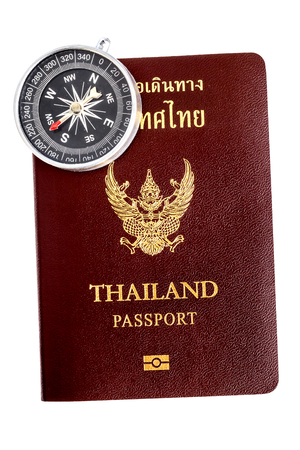 Compass and Thailand passport isolated on white backgroundの写真素材