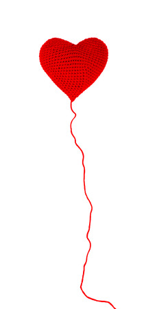 Heart made of red yarn isolated on white