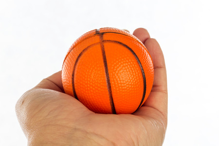 Toy basketball on hand isolated on white backgroundの写真素材