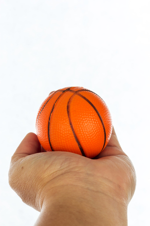 Toy basketball on hand isolated on white backgroundの写真素材