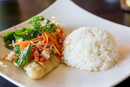 Soft rice and grilled fish Dolly bento with vegetables, selective focus.の写真素材