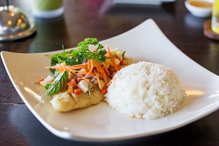 Soft rice and grilled fish Dolly bento with vegetables, selective focus.の写真素材