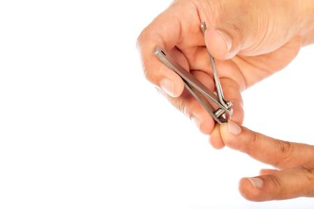 hand manicure with nail clipper isolated on white backgroundの写真素材