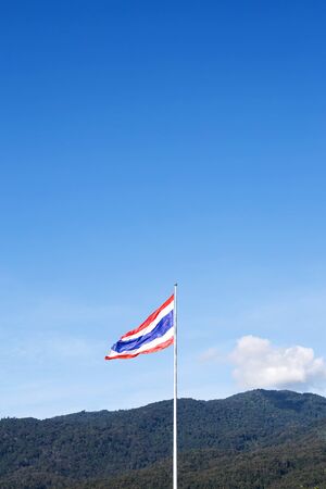 Image of waving Thai flag of Thailand with blue sky background.の写真素材
