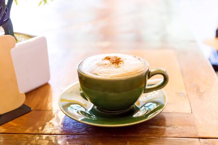 Hot coffee in a white cup on tableの写真素材